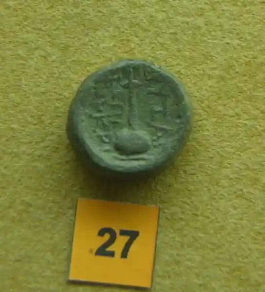 An asymmetrical cross on top of a oblong stand